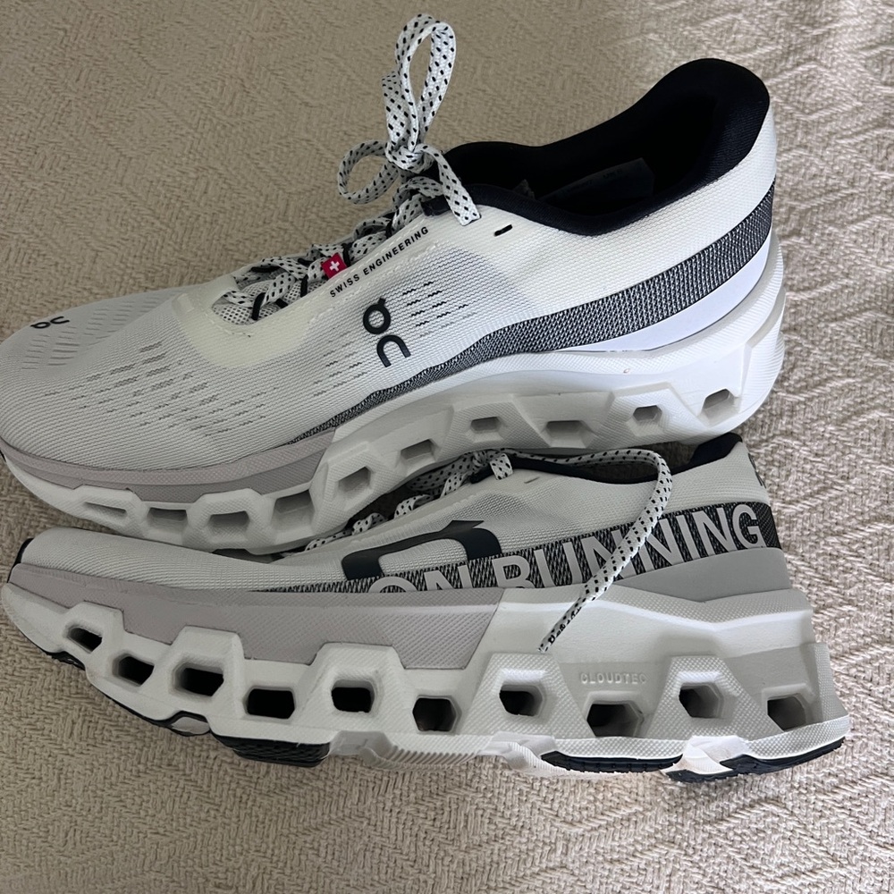 On Running White and Black Athletic Shoes with Modern Cushioning